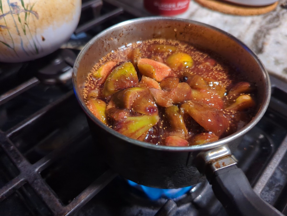 A pot on the stove where you can see figs being cooked down