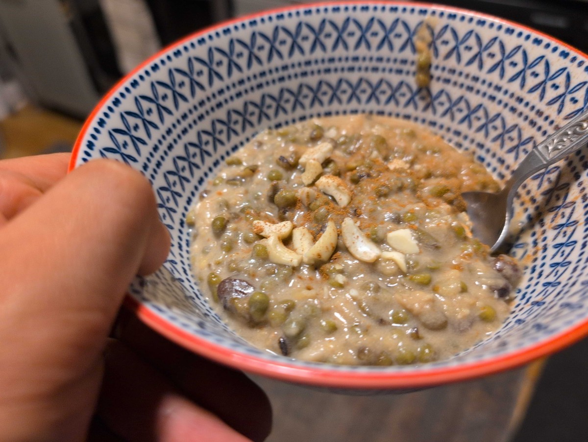 The ginataang monggo in a bowl with some cashews and ground cinnamon