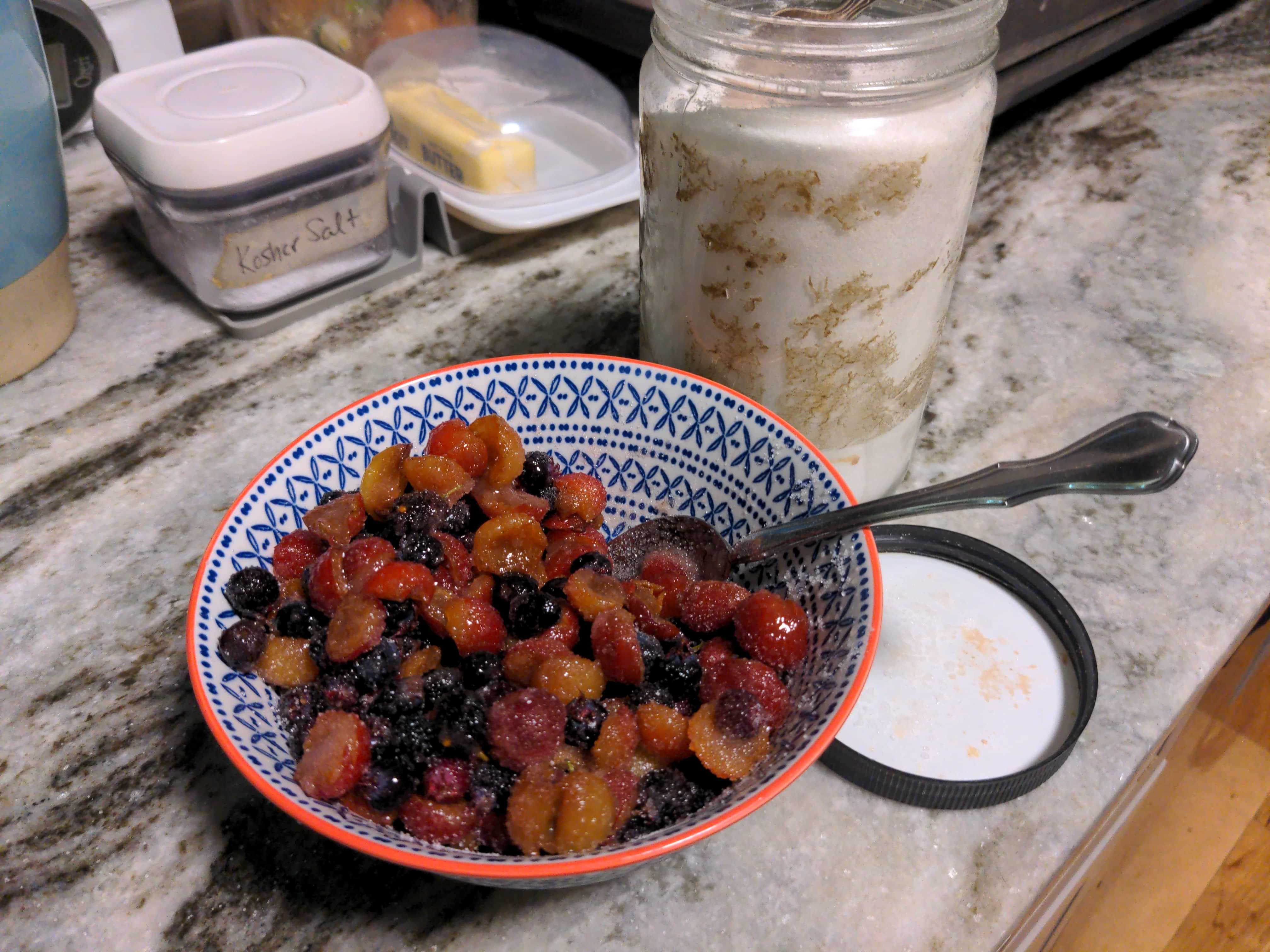 A bowl of fruits coated in sugar