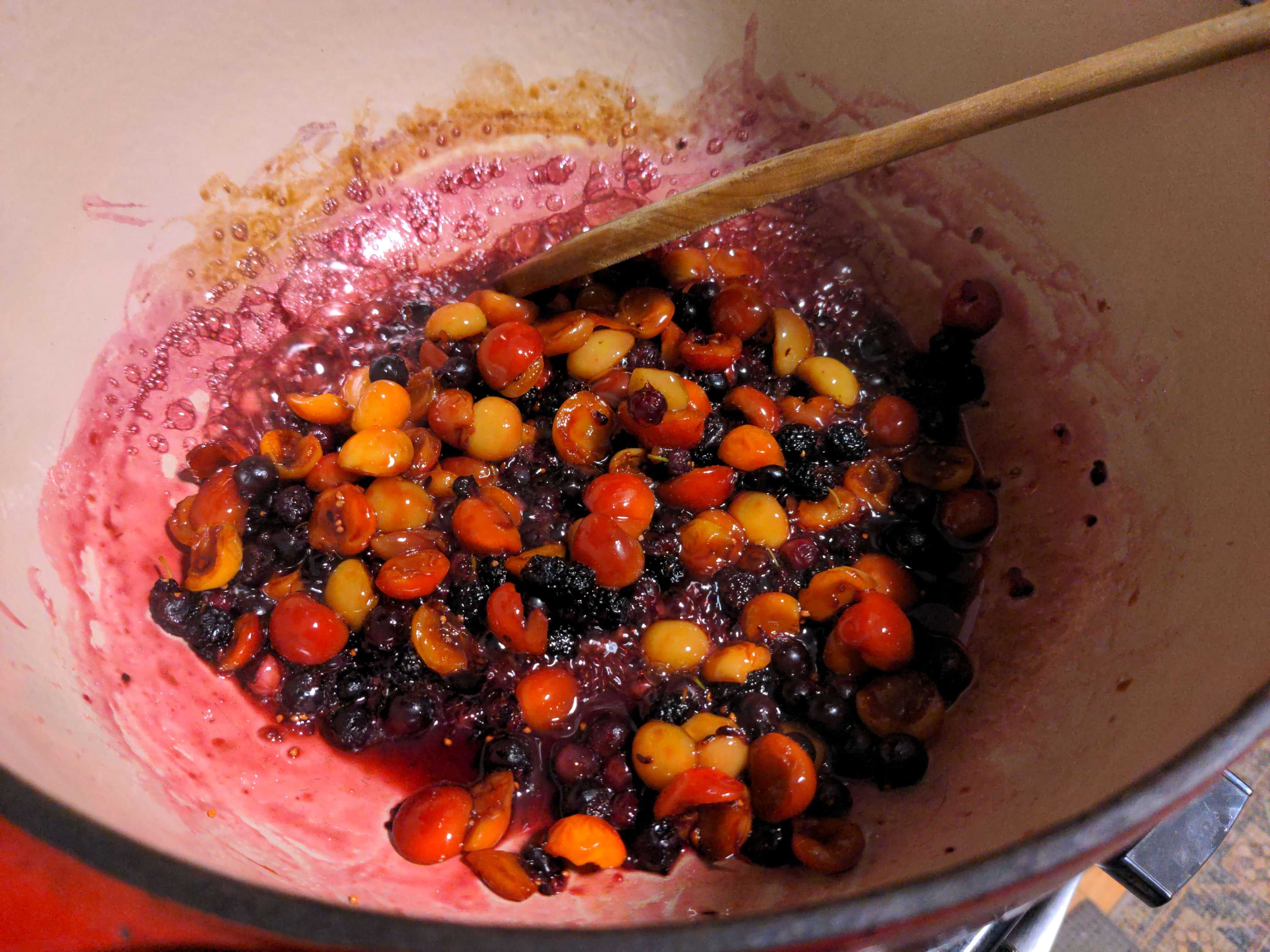 A pot of fruits being cooked and turned into jam